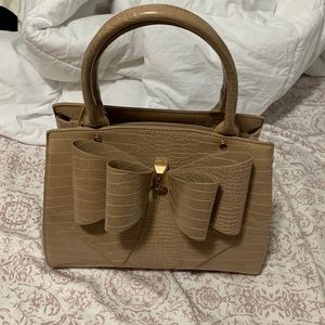brand new purse never used, tan brown color cute bow in front, crocodile print